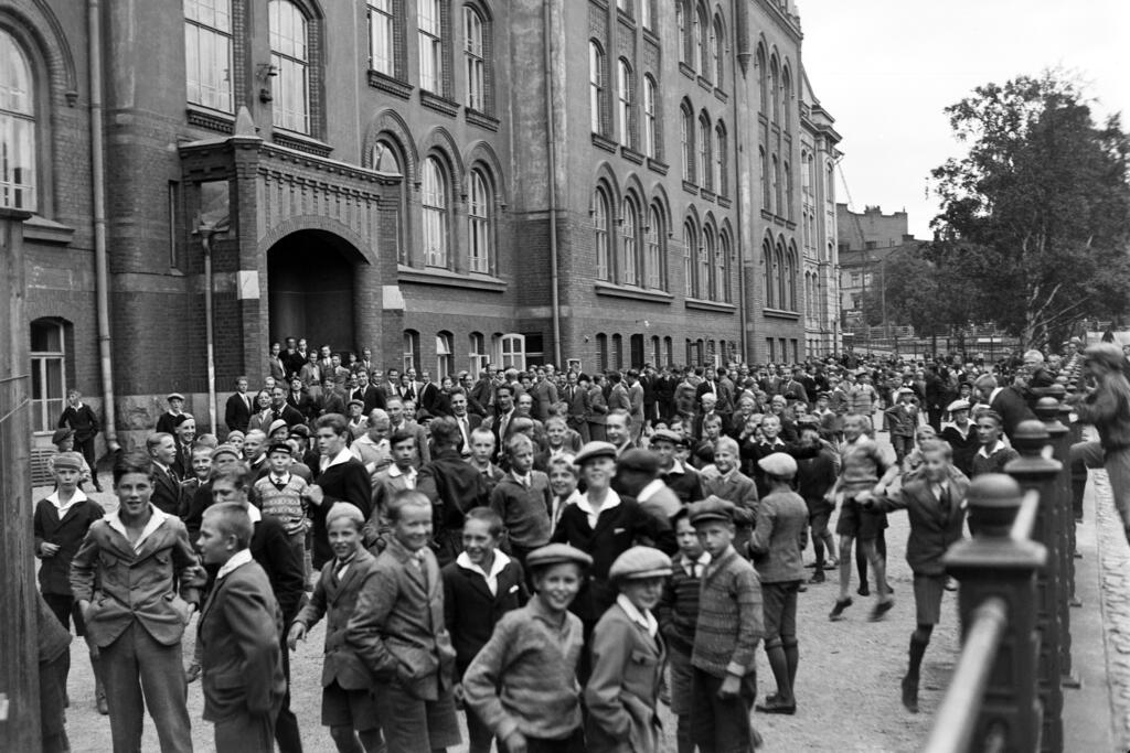 Barn på gården till Normallyceum i Helsingfors, förmodligen på 1930-talet. ”Norssi” är en av de äldsta finskspråkiga skolorna i landet. Den tidigare statliga skolan är numera en del av Helsingfors universitet.  Foto: Helsingfors stadsmuseum / Aarne Pietinen