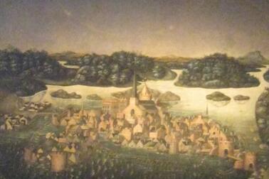 En bild av en tavla som föreställer Stockholm på 1500-talet samt en halo ovanför staden