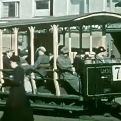 Avomallisessa raitiovaunussa istuu ihmisiä. Vaunun kyljessä on numero 7.