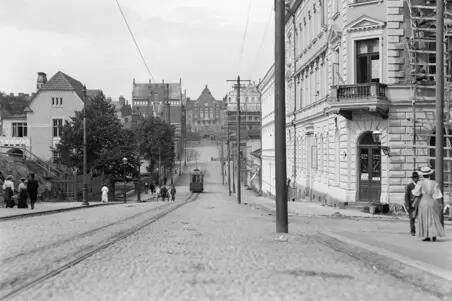 Nikolainkatua (nykyinen Snellmaninkatu) ja sen varrella olevia rakennuksia. Kadun päässä siintää Helsingin yliopiston Fysiolooginen laitos (nyk. Käyttäytymistieteellinen tiedekunta).Kadulla on vain yhdet raitiotiekiskot, joilla raitiovaunu kulkee. Kadulla on myös hevosajoneuvo ja jalkakäytävillä käveleviä ihmisiä.