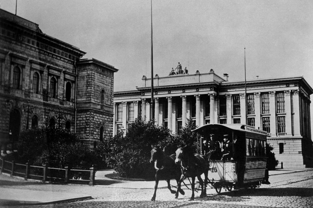 Hästspårvagn på dåvarande Nikolajgatan (vid Snellmansgatan 9). Finlands Bank och i bakgrunden Riksarkivet. 1890-tal. Foto: Helsingfors stadsmuseum / Nils Wasastjerna 