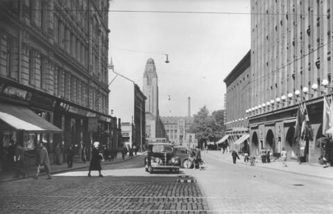 Centalgatan 5, 7, 4, 8. På gatan syns bilar, fotgängare på trottoarerna.