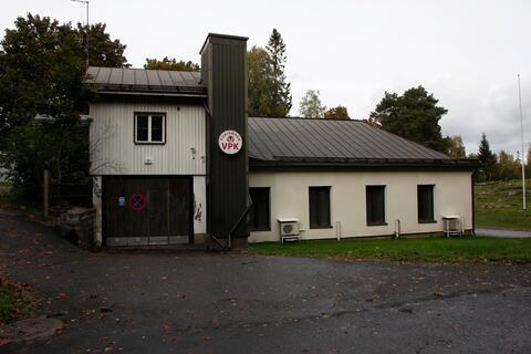 Pukinmäen VPK:n rakennus Eskolankujan suunnasta. Rakennuksessa on pyöreä kyltti, jossa lukee punaisella Pukinmäen VPK.