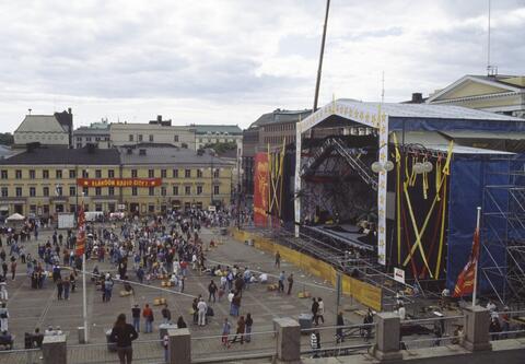 A large stage is buing built on the square. A red banderol says "Long live Radio City" with a Soviet style star on it