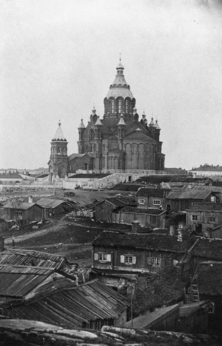 Katajanokka.Taustalla Uspenskin katedraali ja etualalla Katajanokan mökkejä nykyisen Satamakadun ja Katajanokan puiston paikalla. Edessä keskellä tontti 50.