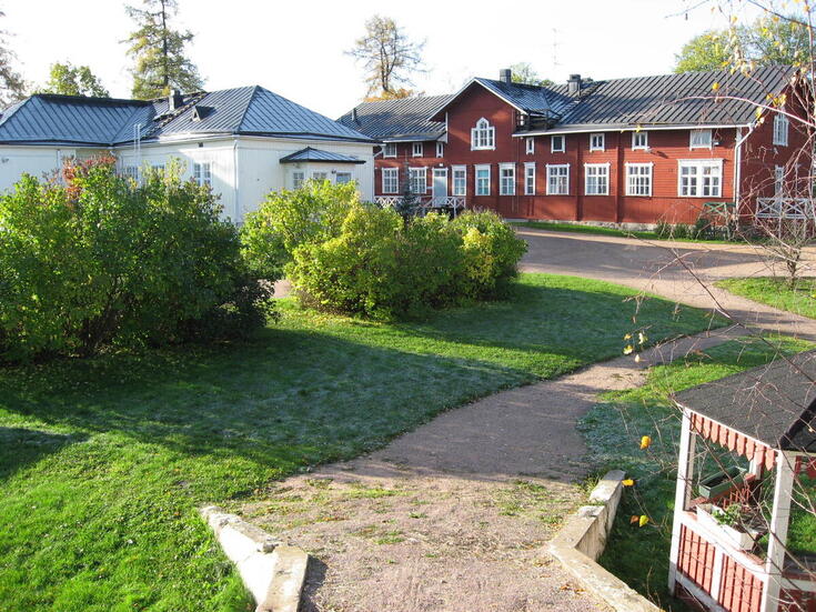 Pitkä, horisontaalinen julkisivu on vaakalaudoitettu ja maalattu punamullalla. Julkisivun keskiosassa molemmin puolin on ristipääty. Eteläpäädyn lasikuistin ikkunoissa on käytetty vaihtelevaa vinoruudutusta. Julkisivun ikkunoiden leveydet ja listoitusmallit vaihtelevat. Pohjoispäädyssä on uusi invaluiska, samoin pääoven vasemmalla sivulla. 1 1/2 kerrosta.
