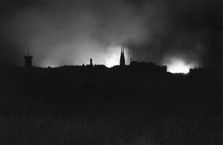 A nocturnal photograph of a burning city.