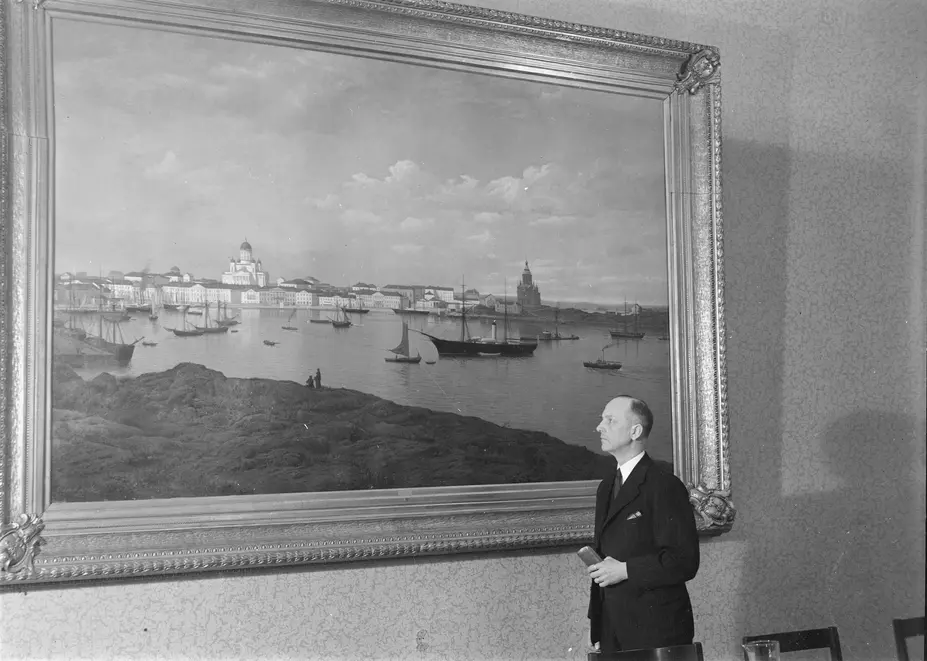 Eero Rydman framför en målning av Helsingfors