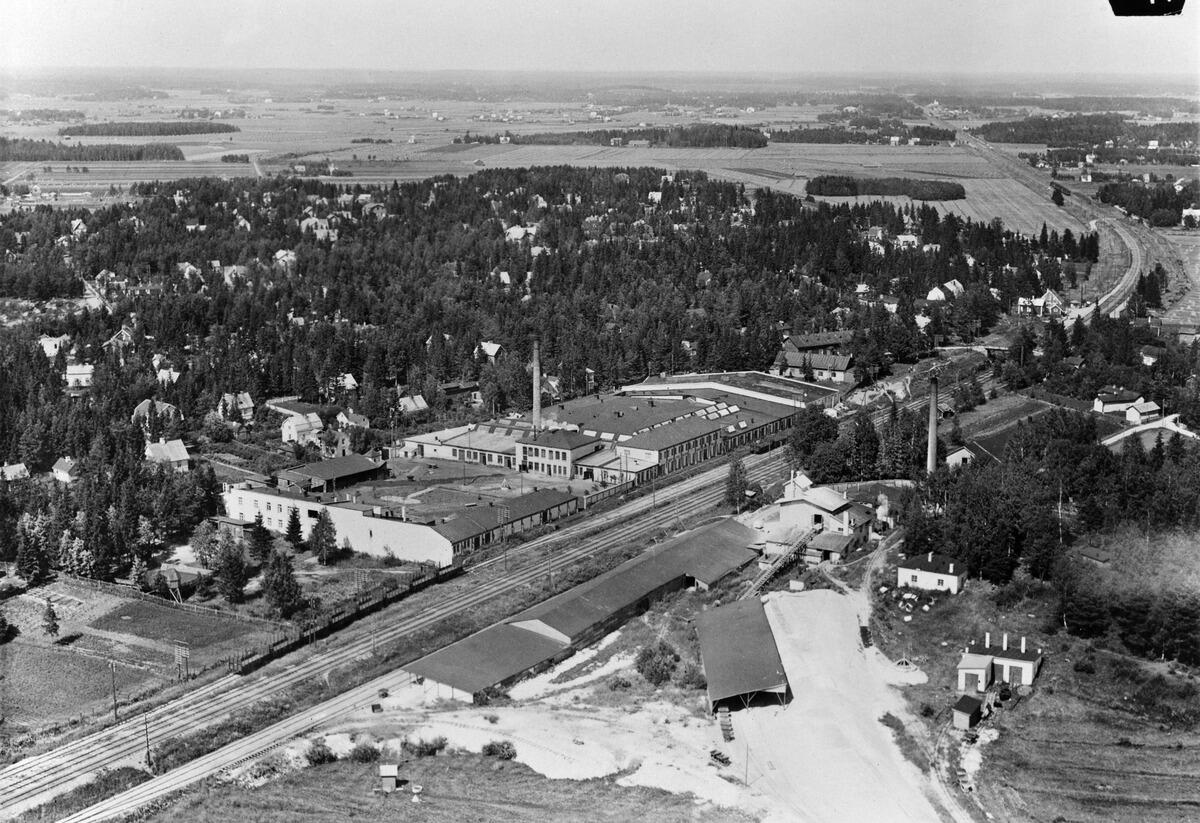 Tapaninkylä, Tapanila, ilmakuva.Sanduddin tehtaat, päärata. Mosabackan lava näkyy vasemmalla ennen Sanduddin tehtaita.