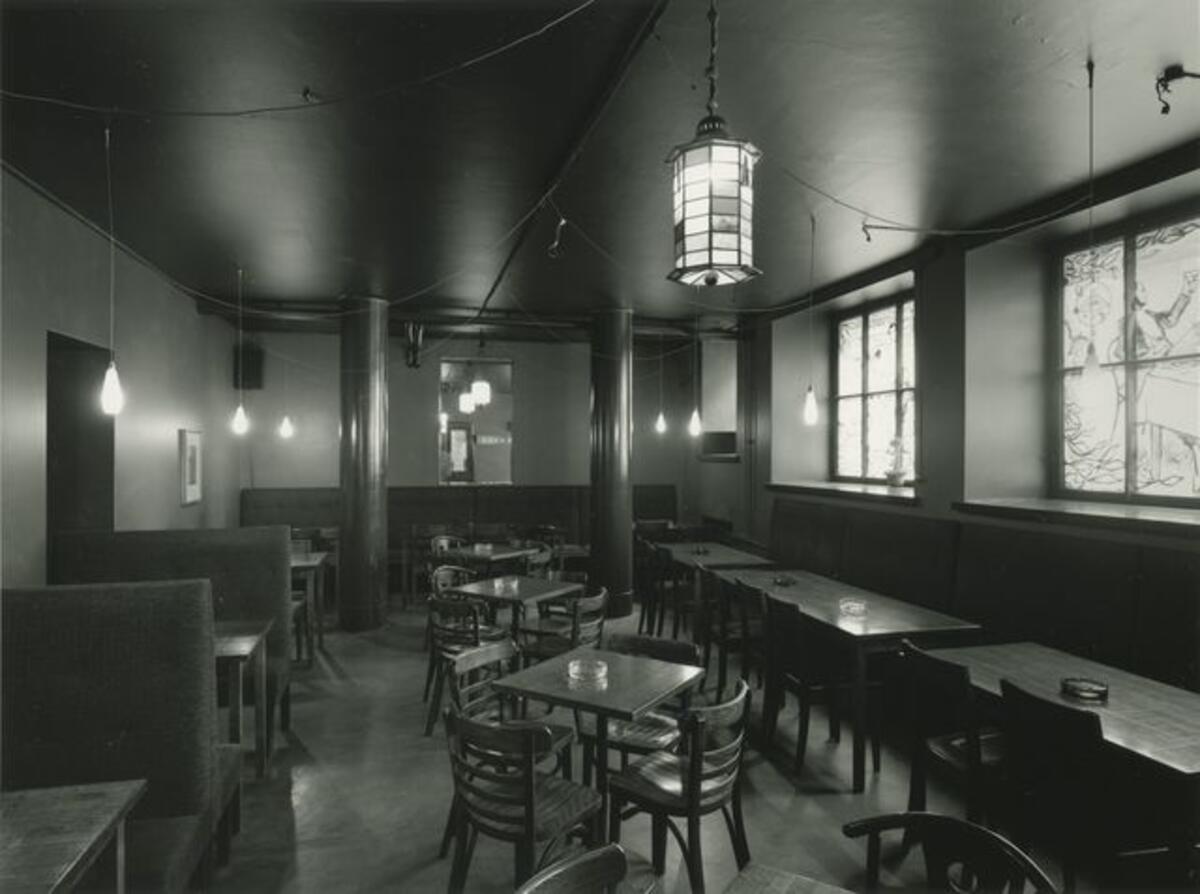 The Savanna restaurant, dining hall; the interior, empty tables and stained-glass windows.